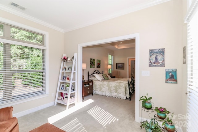 bedroom with ornamental molding and light colored carpet