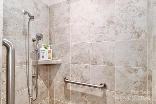 interior details with a tile shower