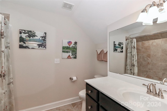 bathroom featuring toilet, curtained shower, vaulted ceiling, tile patterned floors, and vanity