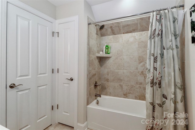 bathroom with shower / bath combo with shower curtain