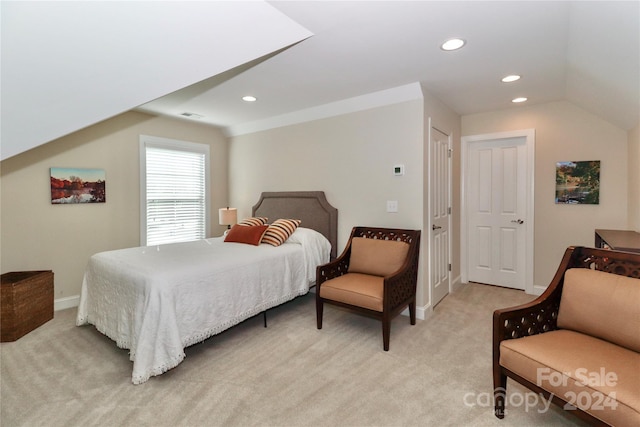 bedroom featuring vaulted ceiling and light colored carpet