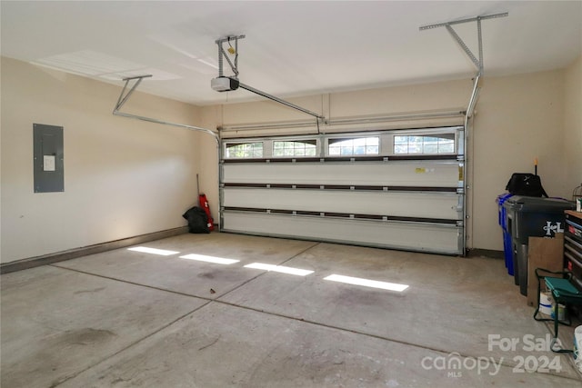 garage featuring a garage door opener and electric panel