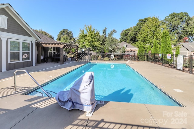 view of swimming pool with a pergola and a patio area