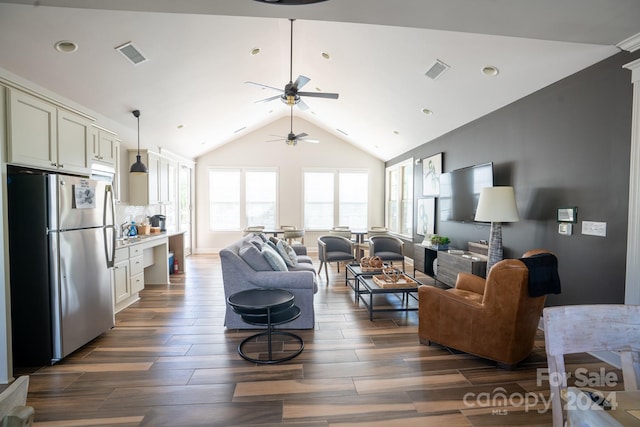 living room featuring lofted ceiling, dark hardwood / wood-style flooring, and ceiling fan