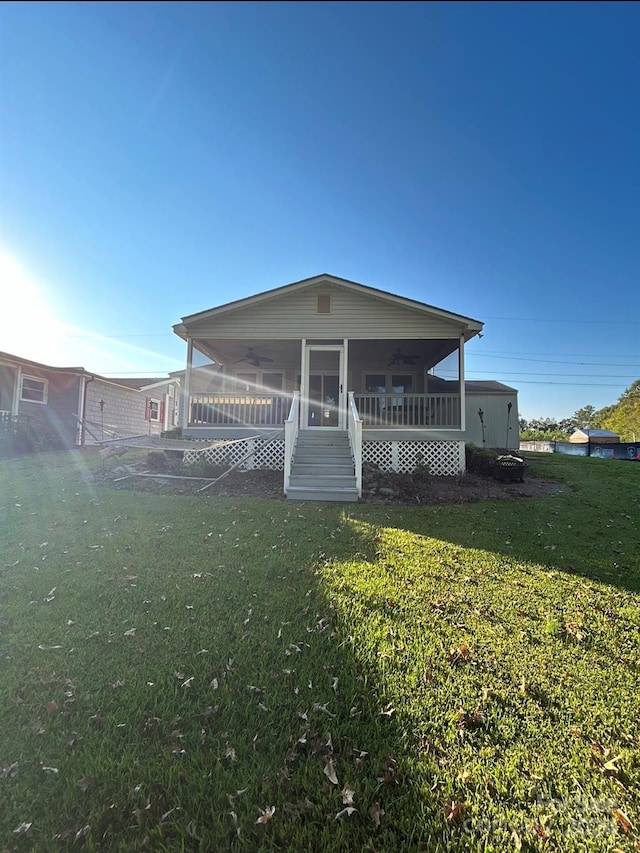 rear view of property featuring a yard