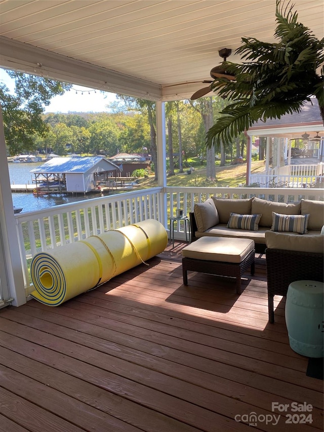 deck featuring an outdoor living space and a water view