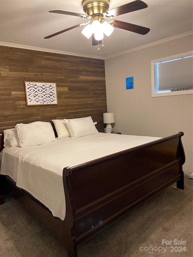 carpeted bedroom featuring crown molding, wooden walls, and ceiling fan