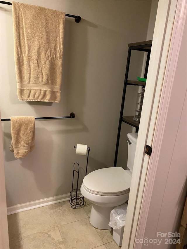 bathroom with toilet and tile patterned floors