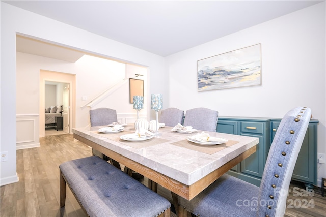 dining space with light hardwood / wood-style floors