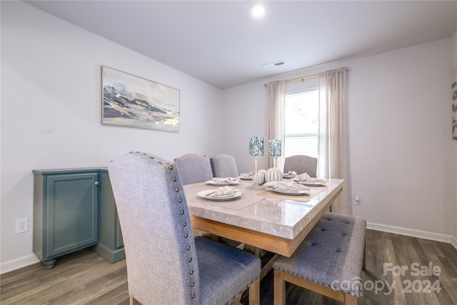 dining space with hardwood / wood-style flooring