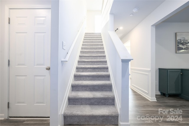 staircase with hardwood / wood-style floors