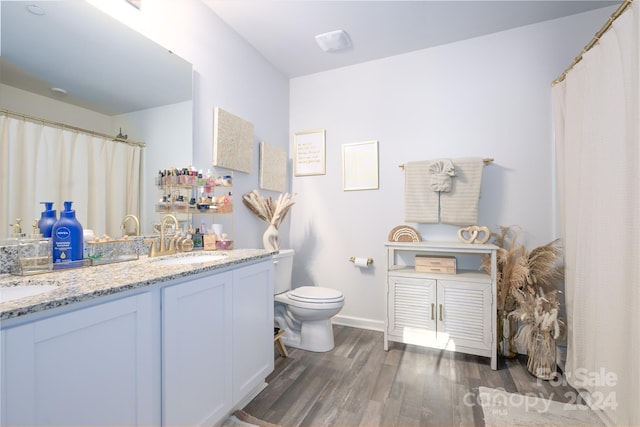 bathroom featuring hardwood / wood-style floors, vanity, and toilet