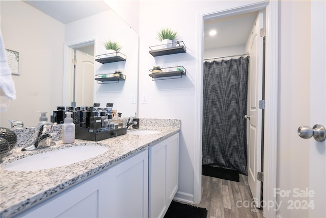 bathroom with hardwood / wood-style floors and vanity