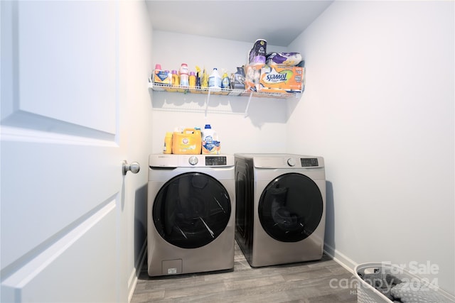 laundry room featuring hardwood / wood-style floors and washer and dryer