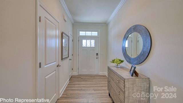 doorway to outside with ornamental molding and light hardwood / wood-style floors