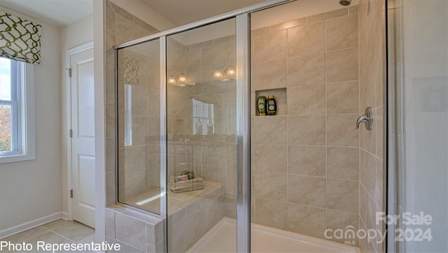 bathroom featuring a shower with shower door and tile patterned floors