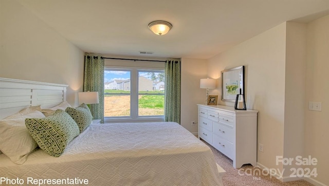 bedroom featuring light colored carpet