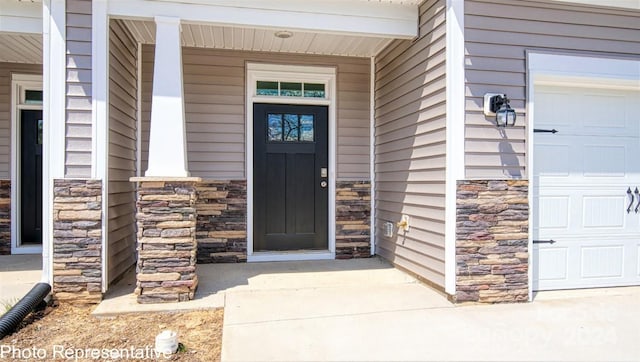 view of exterior entry with a garage