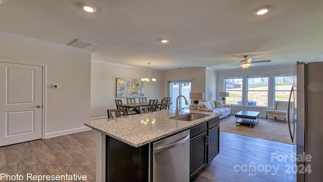 kitchen featuring a kitchen island with sink, crown molding, sink, dark hardwood / wood-style floors, and appliances with stainless steel finishes