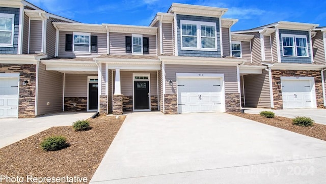 townhome / multi-family property featuring a garage