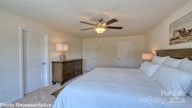 bedroom with light carpet and ceiling fan