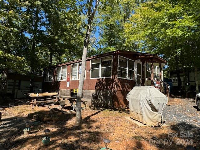 201 Deer Park Rd, Mount Gilead, NC 27306 - view of side of property with a sunroom