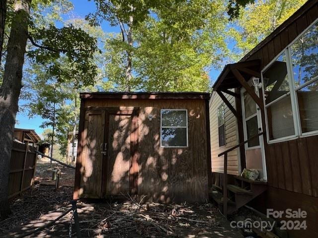 view of property exterior featuring a shed