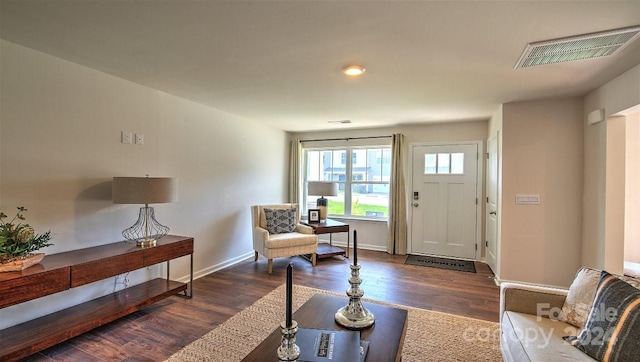 interior space featuring baseboards, dark wood-style flooring, and visible vents