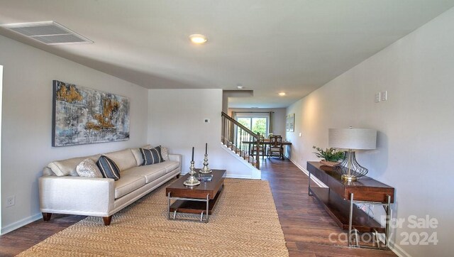 living room with recessed lighting, stairway, wood finished floors, visible vents, and baseboards