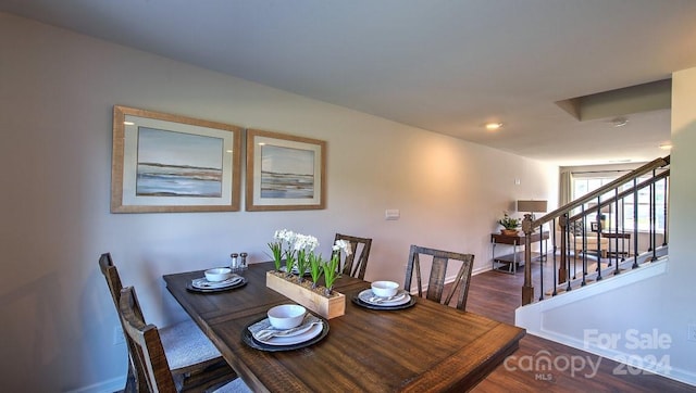 dining space featuring baseboards, wood finished floors, recessed lighting, and stairs