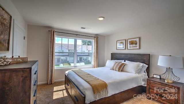 bedroom with visible vents, carpet flooring, and baseboards