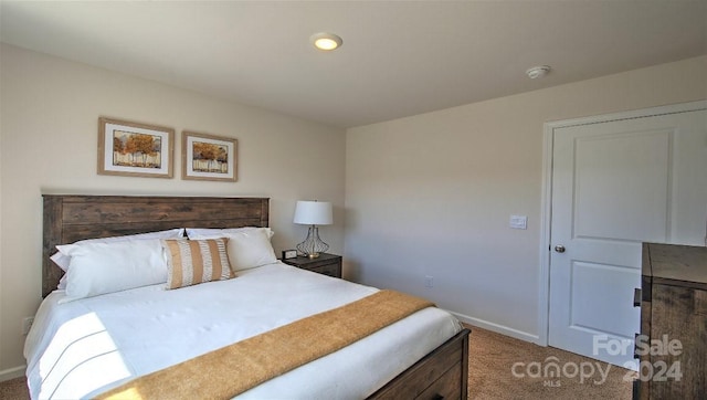 carpeted bedroom featuring recessed lighting and baseboards