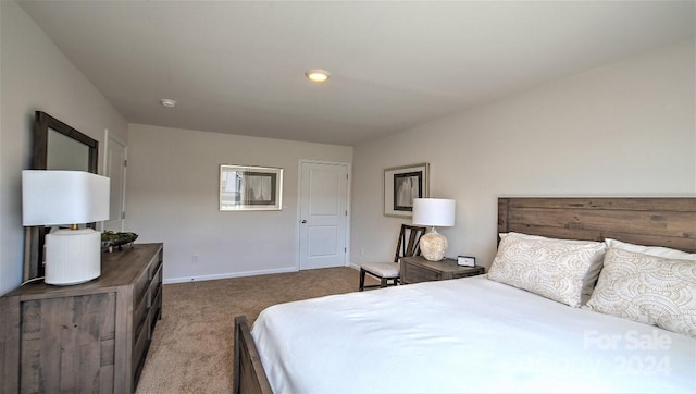bedroom with baseboards and carpet