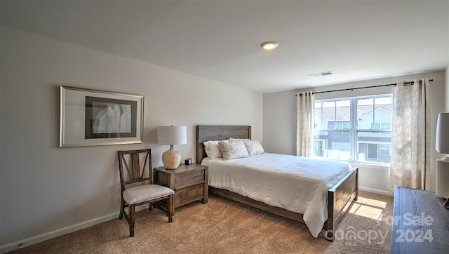 bedroom featuring light carpet, visible vents, and baseboards