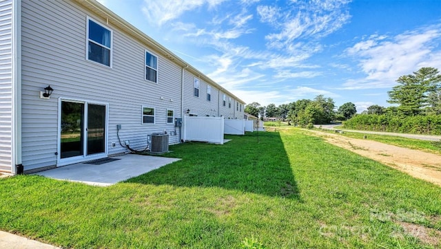 back of property featuring a lawn, a patio area, and central AC unit