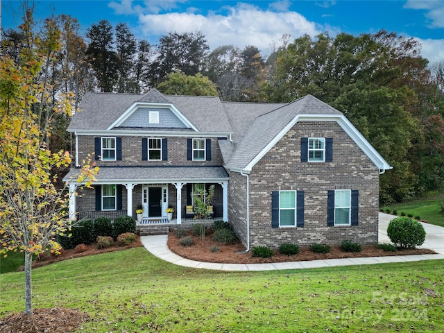 view of front of house featuring a front lawn and covered porch