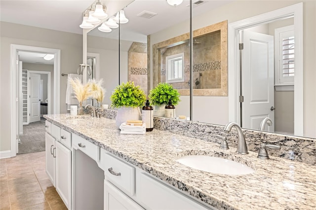 bathroom featuring vanity, walk in shower, and tile patterned floors