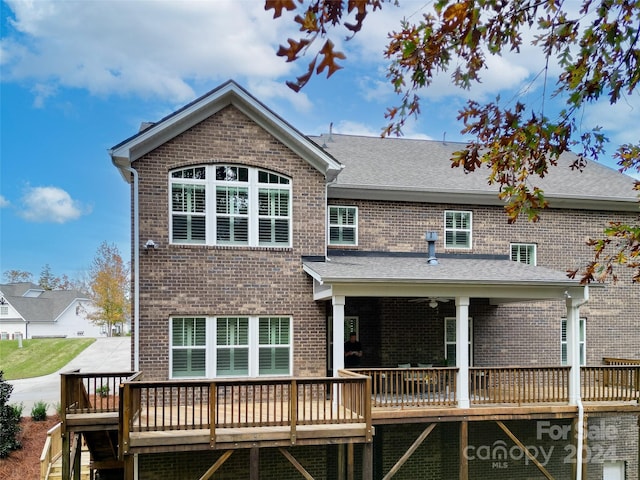 back of house featuring a deck