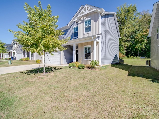 view of front of home with a front yard and a garage