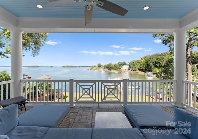 view of patio featuring a water view and ceiling fan