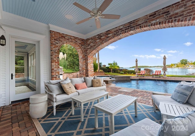 view of patio with ceiling fan, a swimming pool with hot tub, outdoor lounge area, and a water view