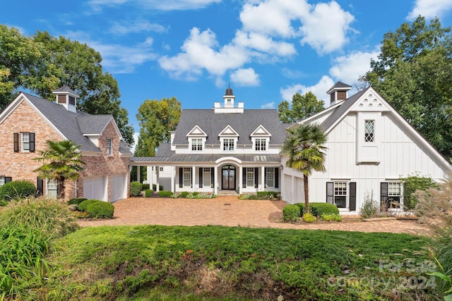 view of front of property featuring a garage and a front lawn