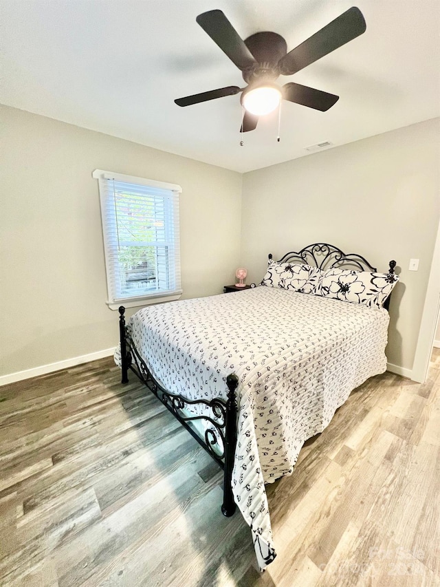 bedroom featuring hardwood / wood-style floors and ceiling fan