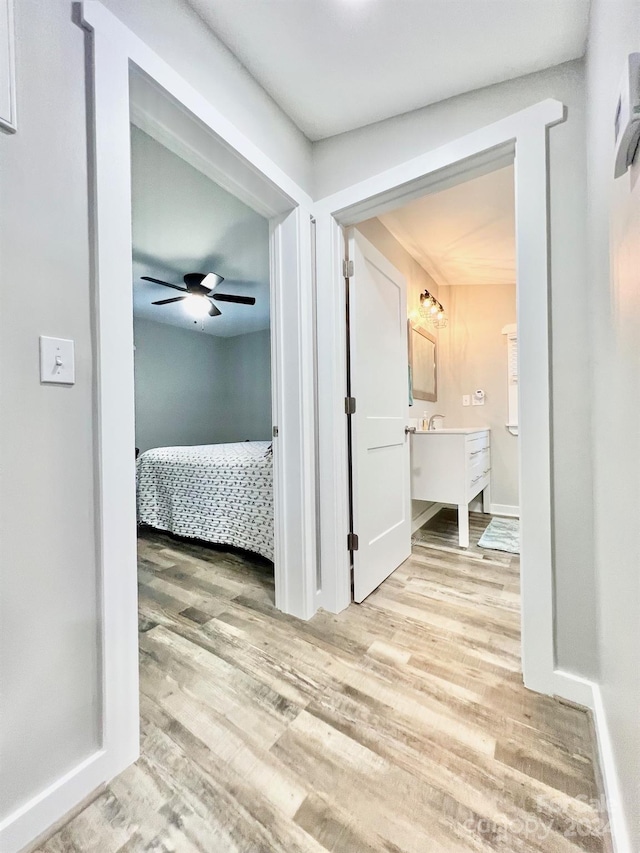 corridor with hardwood / wood-style floors