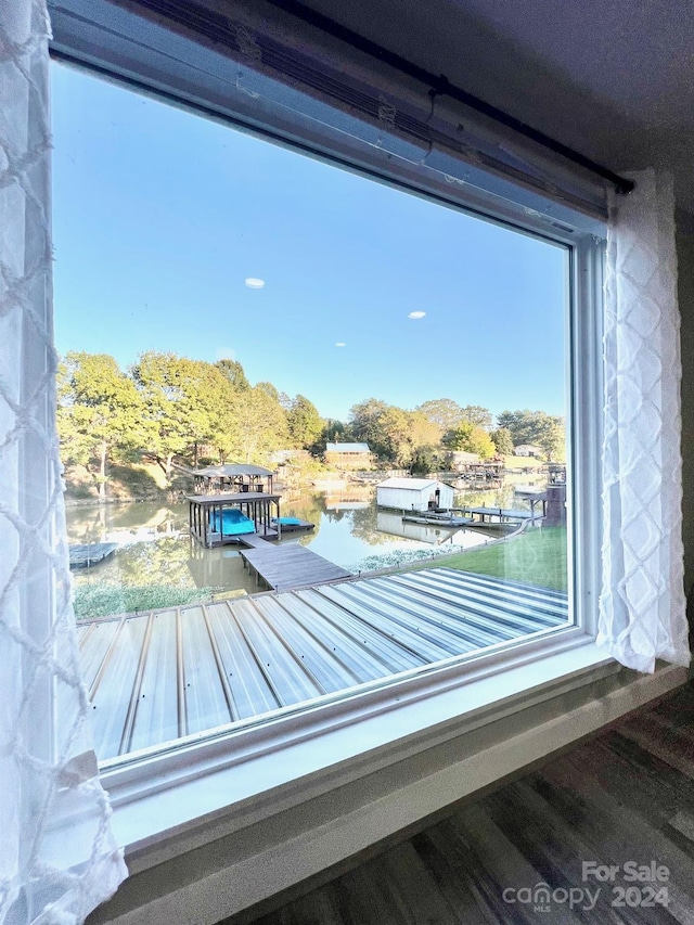 room details featuring hardwood / wood-style flooring and a water view