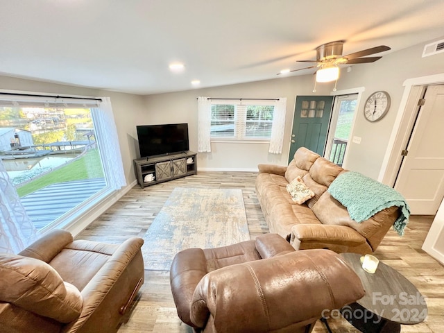 living room with light wood-type flooring, lofted ceiling, and ceiling fan