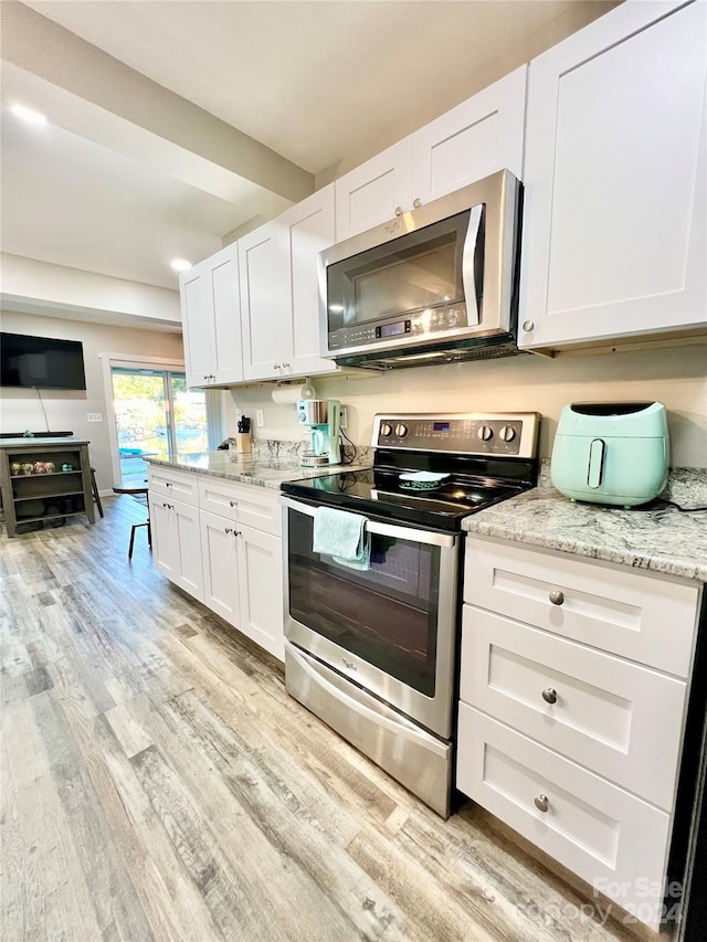 kitchen featuring white cabinetry, appliances with stainless steel finishes, and light hardwood / wood-style floors