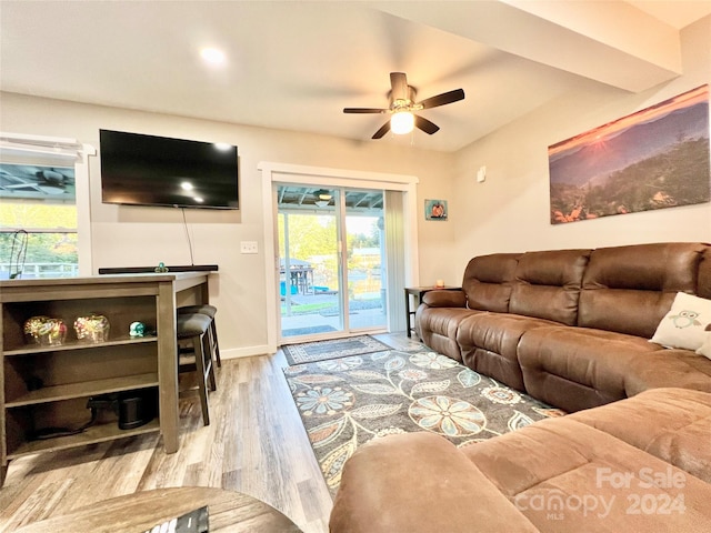 living room with light wood-type flooring and ceiling fan