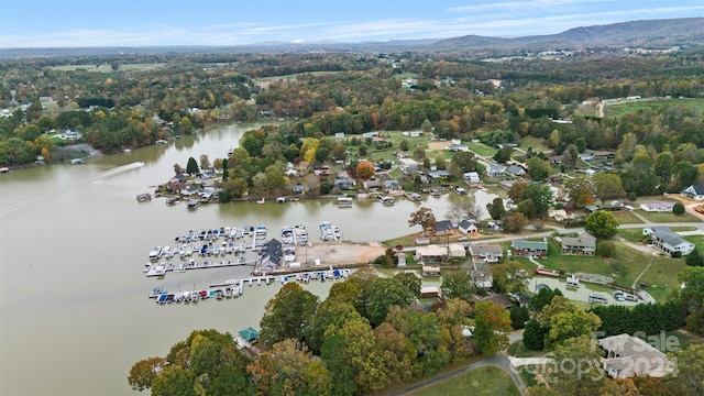 drone / aerial view with a water and mountain view