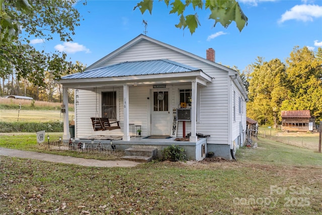 bungalow-style house featuring a porch and a front yard